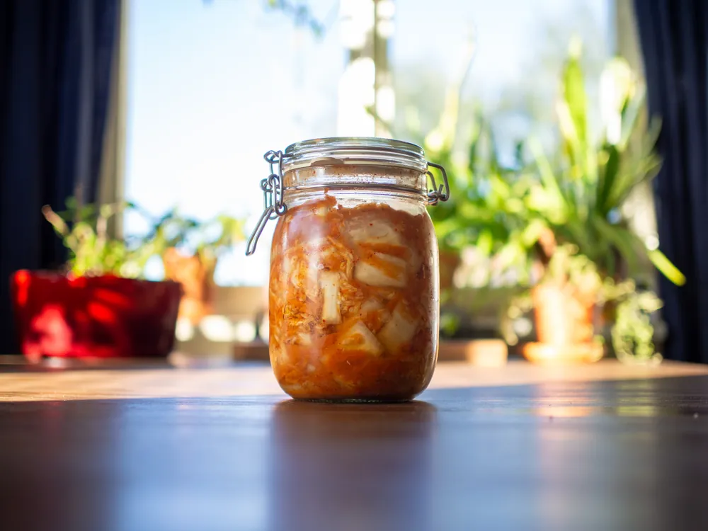 A jar of homemade kimchi on a table by a sunny window: The Short List's featured recipe